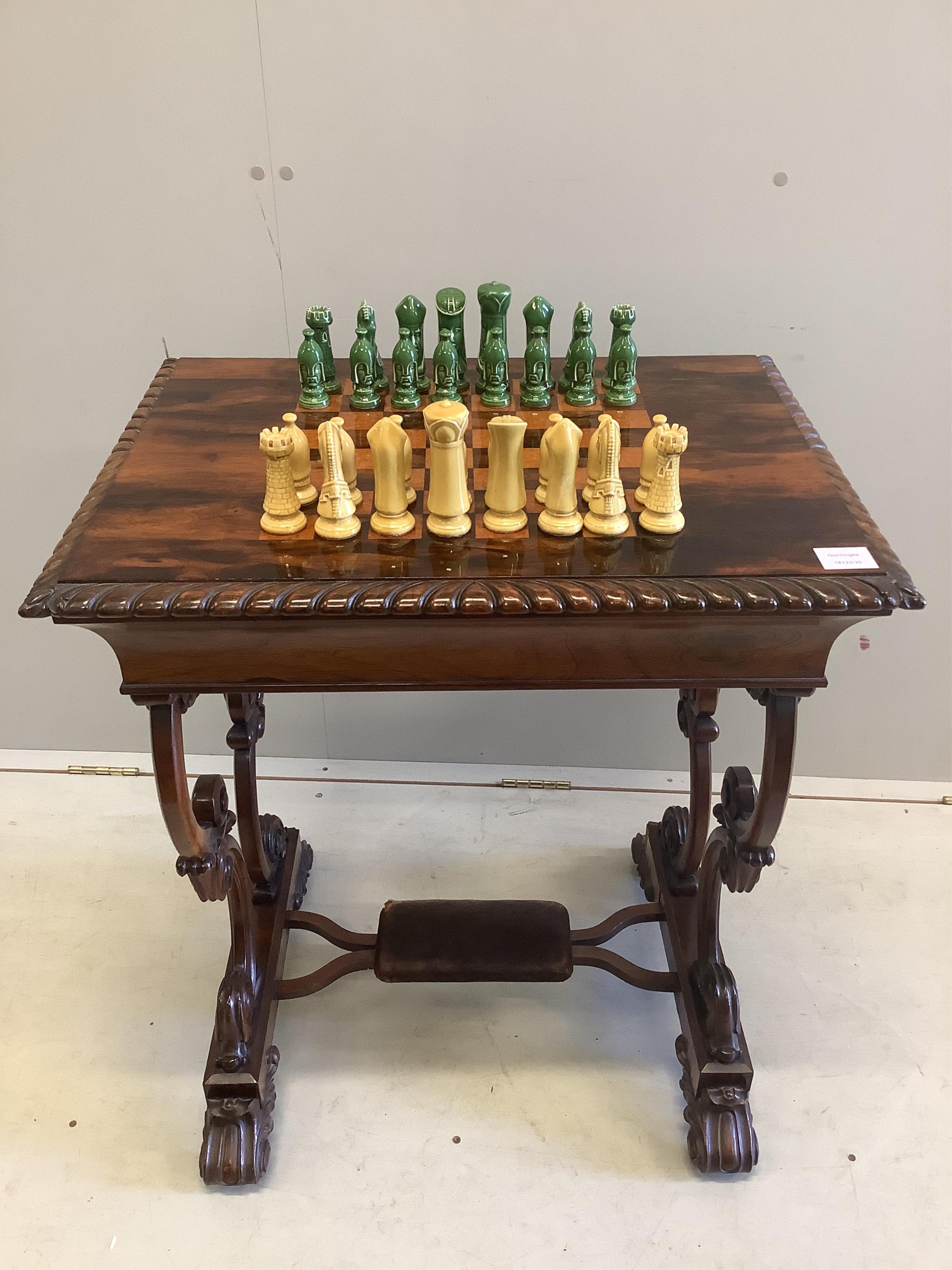 A Victorian rosewood chess top table, with chess pieces, width 66cm, depth 50cm, height 76cm